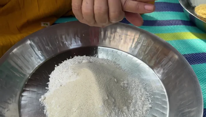 Prepare the dough: Mix flour, semolina, salt, and oil. Add water gradually and knead into a tight dough. Cover and let it rest for 30 minutes (66.88).