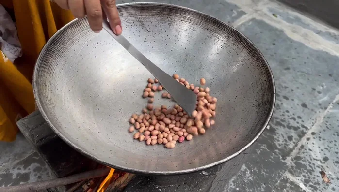 Roast peanuts until nicely browned.
