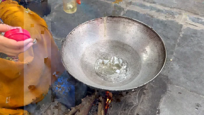 Heat oil in a pan. Add cumin and mustard seeds, then add the chili-garlic-cumin paste.