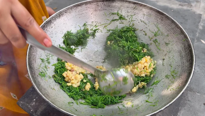 Add half of the cooked Tur dal.