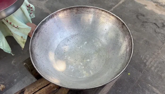 Heat a pan with water and lemon juice to prevent blackening. Place a plate inside the pan.