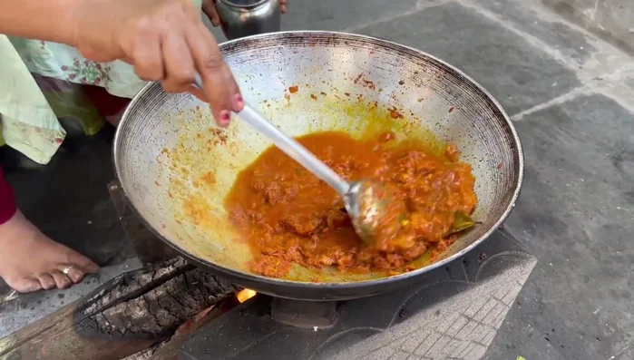 Once the gravy masala is fried, add water, salt, and fresh cream (or milk). Add Kasturi methi (fenugreek).