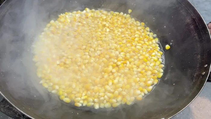 Let the steamed corn kernels cool down.