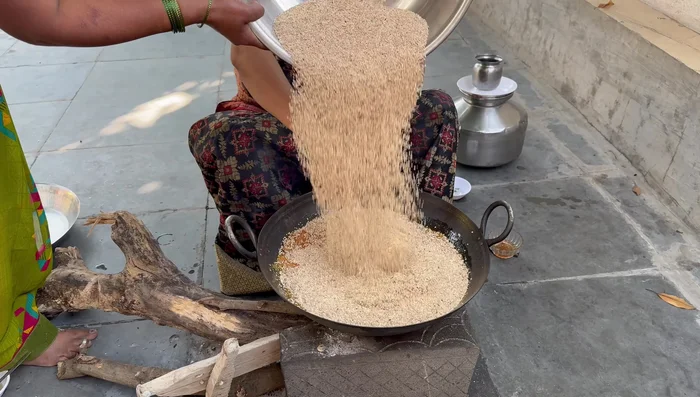 Add the roasted sesame seeds and ground peanuts to the jaggery paste. Mix well.