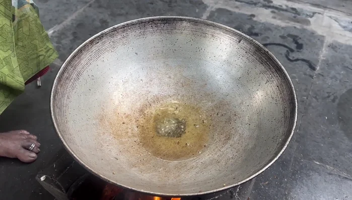Grind two to three green chilies and garlic into a paste.