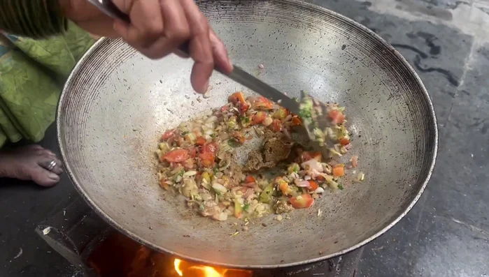 Add the ground sesame-coconut mixture, turmeric, coriander powder, and red chili powder. Fry well.