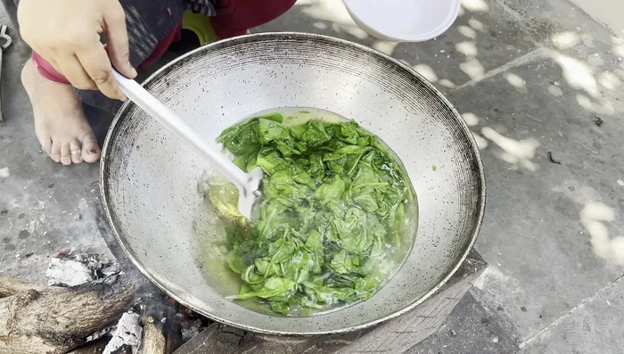 Grind the steamed spinach into a fine paste using a mixer.