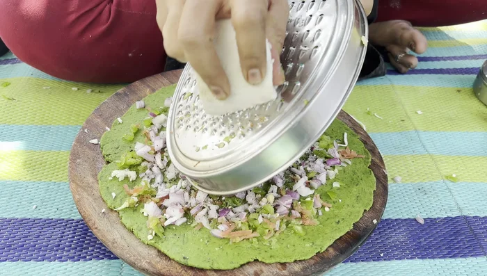 Spread paneer evenly over the mixture.