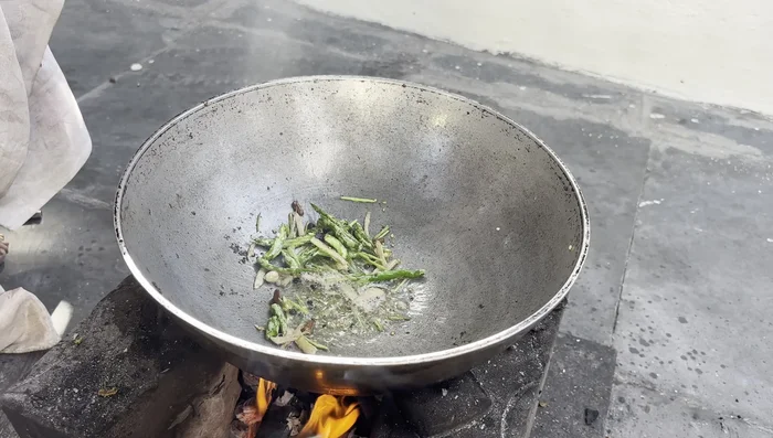 Add the curd, cashew paste, and fresh cream mixture to the sautéed spices; simmer until thickened.