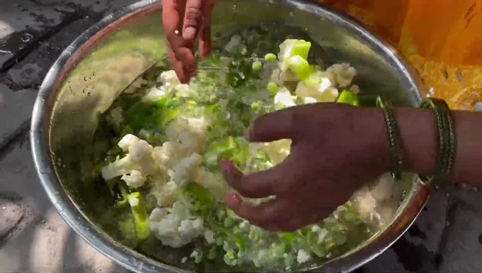 Add all chopped vegetables except coriander and capsicum to the cooker. Cook with one or two spoons of water.