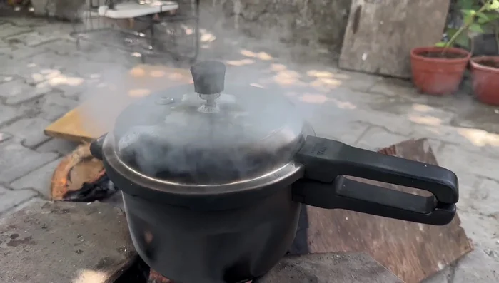 Boil potatoes in a cooker. Once cooked, peel and cut them into pieces.