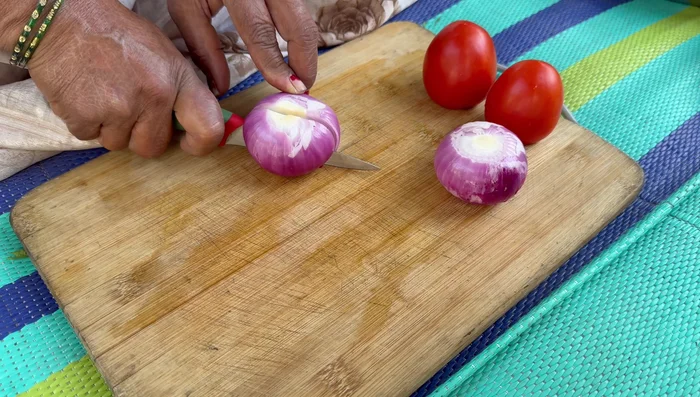 Finely chop the onion, tomatoes, green chilies, and coriander leaves.
