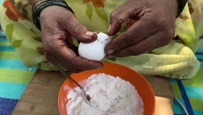 Separate egg whites from yolks and beat the whites until smooth. Add a little water and optional food coloring.