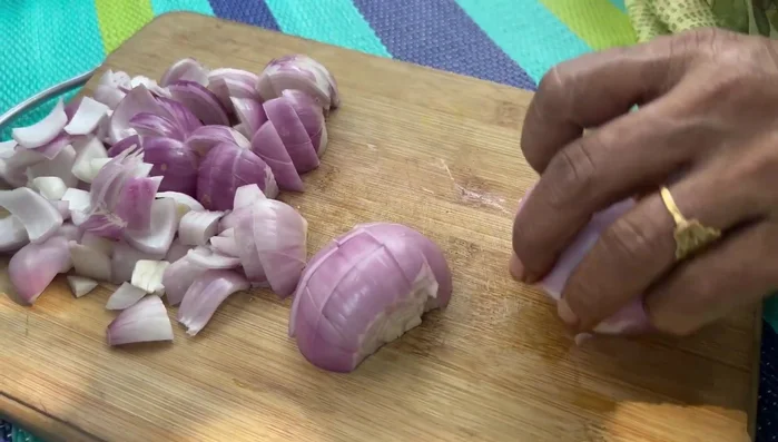 Cut onions, capsicum, green chilies, ginger, and garlic into small pieces.
