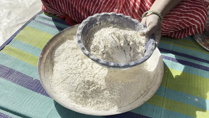 Knead the Dough: Sift the flour. Knead a smooth, firm dough using sifted flour and salt. Add water gradually to achieve desired consistency. Apply oil to prevent the dough from drying out.