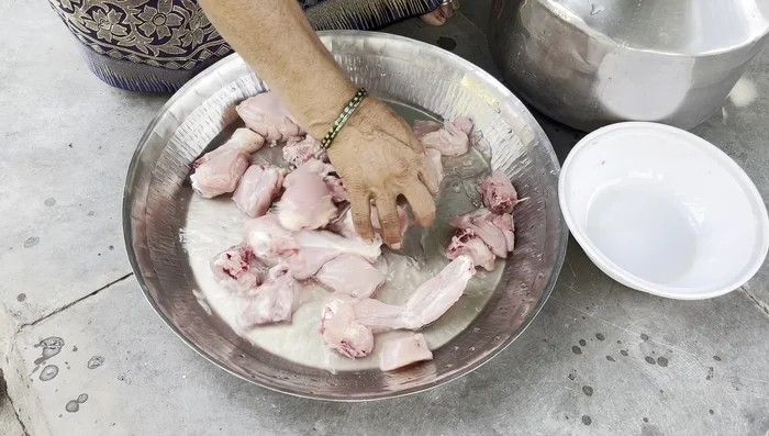 Wash the chicken thoroughly with two or three changes of water.