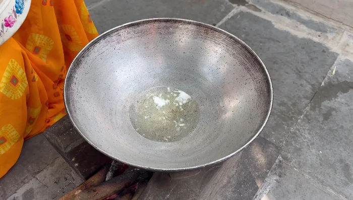 Heat oil in a pan. Add mustard seeds, cumin seeds, asafoetida, turmeric powder, and chopped chilies. Fry for 1-2 minutes.