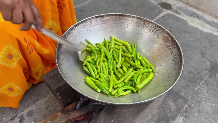 Add salt and fry the chilies until slightly soft.