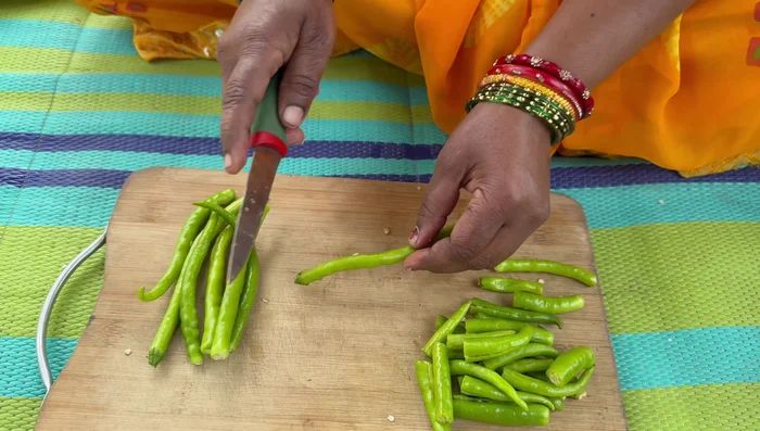 Cut chilies into two parts and make a slit in the middle.