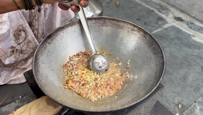 Add the finely chopped garlic, ginger, and green chilies. Fry until fragrant.