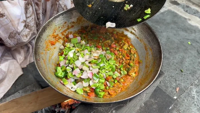 Add chopped coriander, onion, and capsicum. Mix everything together and cook until heated through.
