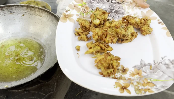 Remove bhajis with a slotted spoon and drain excess oil.
