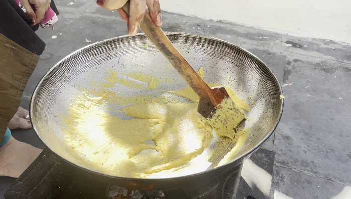 Add a little milk to the frying flour and continue cooking until it thickens.
