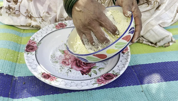 Transfer the mixture to a tray for easier kneading. Knead the mixture well with both hands until it's light and fluffy.
