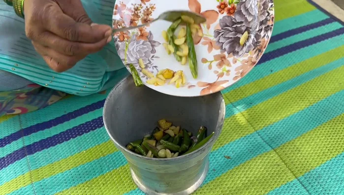 While the Gilkyach steams, grind the roasted chilies, ginger, and garlic into a paste.