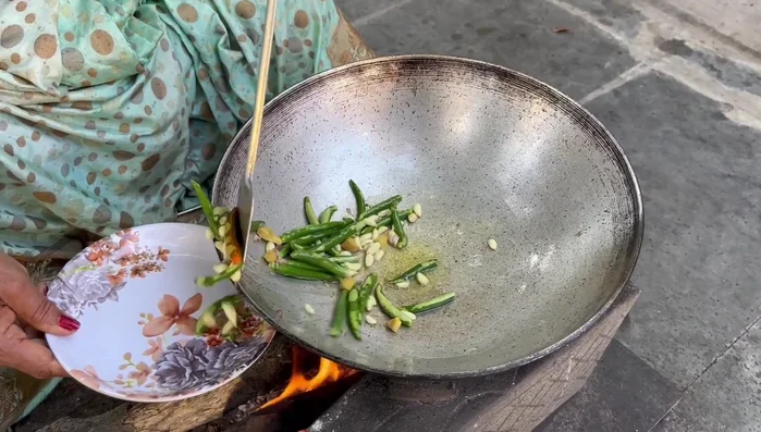 Remove the roasted chilies, ginger, and garlic from the pan, reserving some oil.