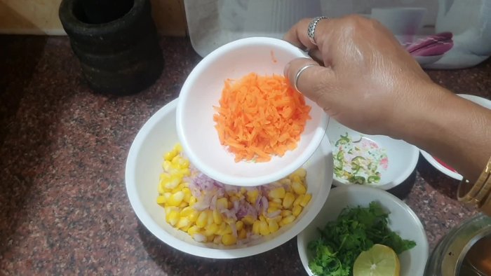 Combine the cooked sweet corn with the prepared vegetables.