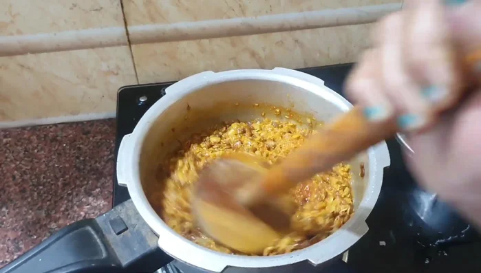 Mash the lentils and adjust water consistency as needed. Add more water if required.