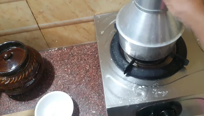 Place the pudding pot in the oven with water. Close the oven and let it steam.