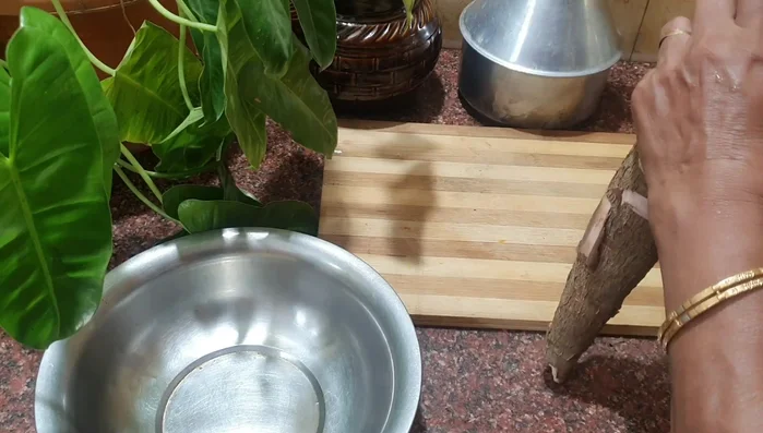 Peel the tapioca. Make a slight cut from the side and peel off the skin. A good tuber will peel easily.