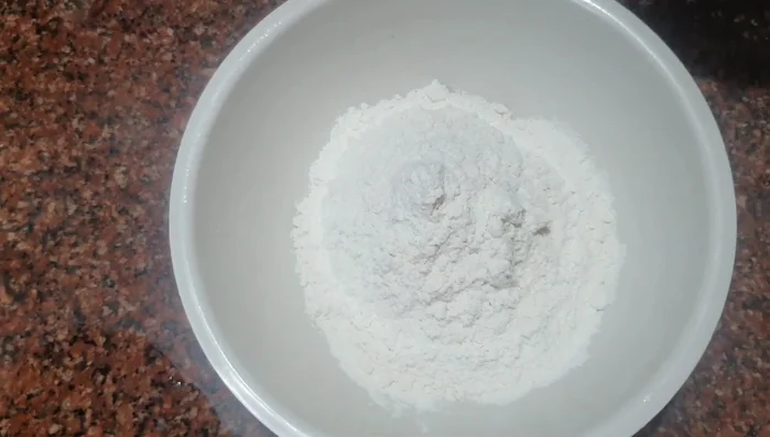 Prepare a batter using maida flour, rice powder, salt, and water (add turmeric powder or food coloring for extra color).