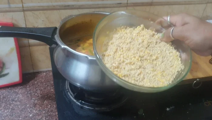 Once the rice is cooked, mix it with the prepared sambar. (Timing not specified in the transcript)