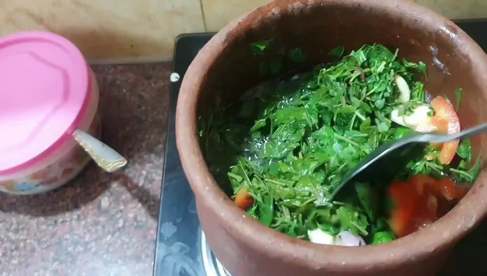 Once the greens have reduced in volume, lower the heat and continue cooking until tender.