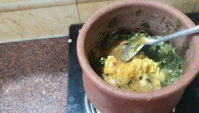 Add the tamarind solution, coconut paste (if using), and salt to the cooked greens. Mix well.