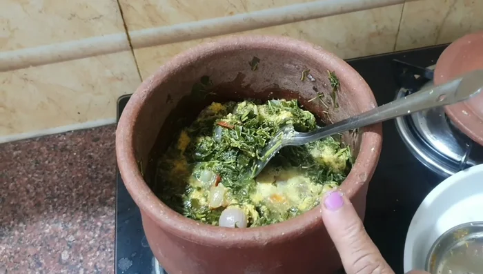 Gently stir the greens to combine all the ingredients.