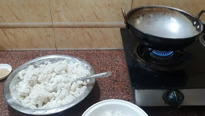 Heat ghee in a pan. Add shredded coconut and fry until lightly browned. Add white sesame seeds and fry until fragrant. Remove from heat and mix.