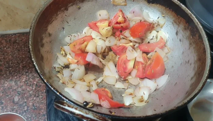 Add tomatoes, salt, and cook until softened (100.96).