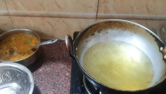 Heat cooking oil in a pan. Once hot, carefully add the marinated cauliflower florets to the pan, ensuring not to overcrowd it. Fry on medium heat, turning occasionally, until golden brown and crispy.