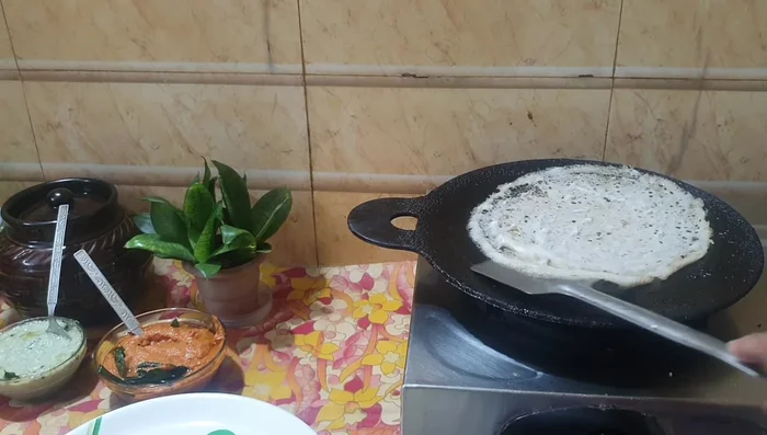 Flip the dosa and cook the other side until golden brown.