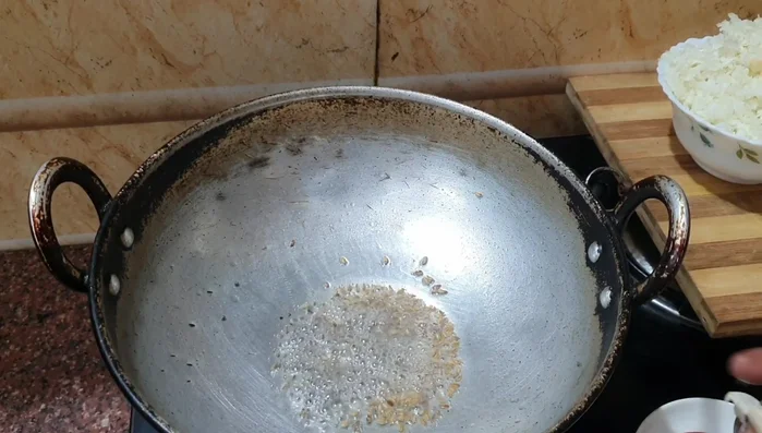 Add grated garlic and curry leaves for aroma.