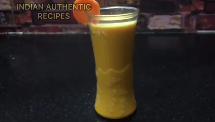 Add the carrot juice, milk, sugar, and ice to a blender.