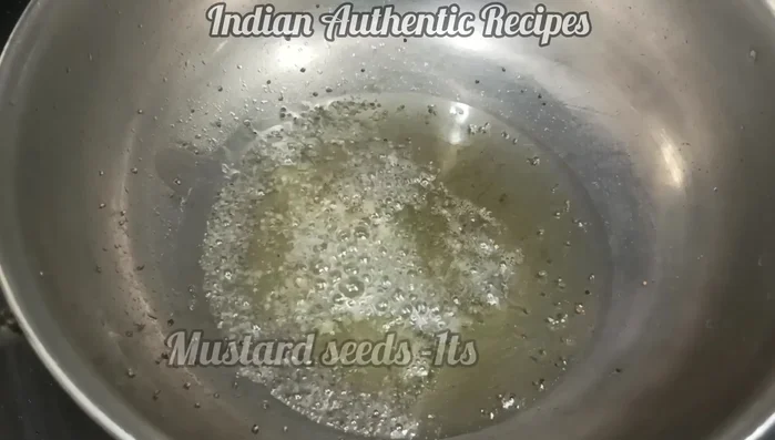 Add mustard seeds and fry until they splutter. Add chopped onion and fry for 2 minutes.