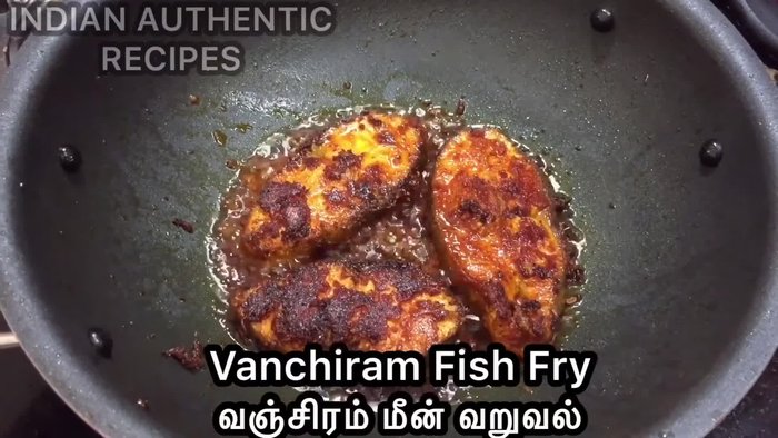 Carefully place the marinated fish in the hot oil.