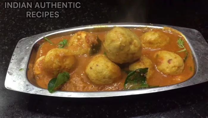 Make the gravy (kulambu). Add spices and other ingredients to create the gravy base. The exact recipe is not fully transcribed, but it appears to involve various spices including garam masala.