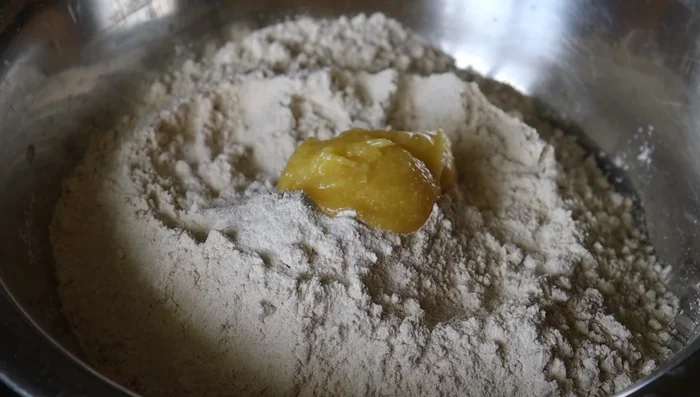 Seal the edges tightly, shaping it into a ball.