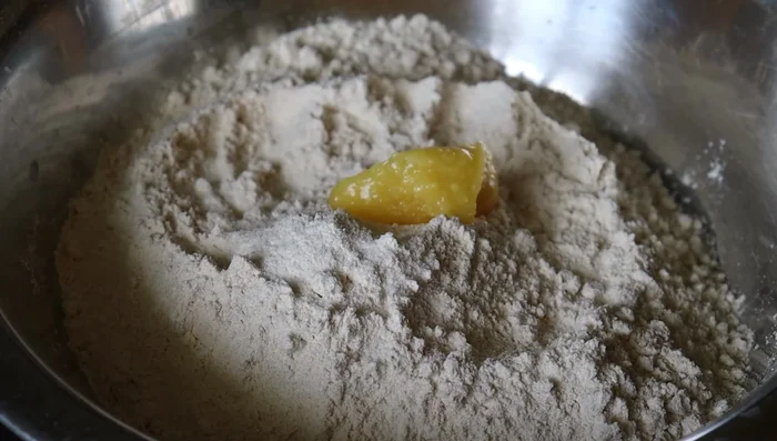 Add the prepared filling to the center of the rolled dough.